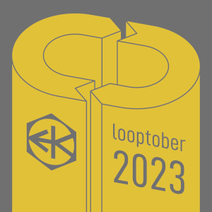 Cover artwork for the album Looptober 2023. A grey field with an isometric view of a yellow loop symbol extruded downward. In the same grey as the background, the Electric Keet logo appears on the left side and the words “Looptober 2023” in lowercase on the right, all angled to match the loop symbol.